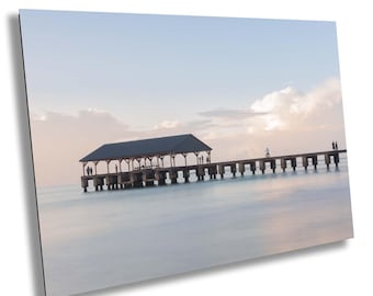 Beautifully calm sunrise over Hanalei Pier on Hawaiian island of Kauai: Beach and ocean scene for perfect wall decor with memories of Kauai
