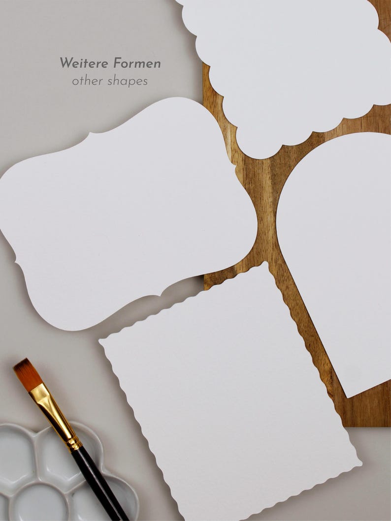 May include: Four blank white paper shapes with scalloped edges. The shapes are a rectangle, a square, a cloud, and a teardrop. The shapes are on a wooden surface. The text "Weitere Formen" and "other shapes" is written in gray text on a light gray background.