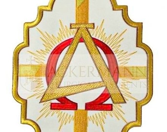 May include: A white oval-shaped patch with a gold embroidered border. The center features a gold embroidered triangle with a red omega symbol inside. The triangle is surrounded by a gold embroidered cross and a sunburst design.