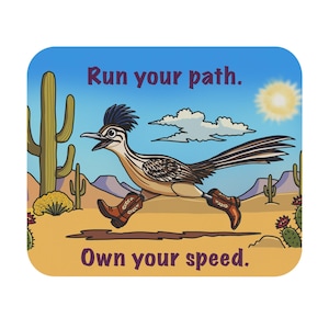May include: A rectangular sticker featuring a cartoon roadrunner wearing brown cowboy boots, running through a desert landscape with cacti, mountains, and a sun. The text reads Run your path. and Own your speed. in dark purple lettering.