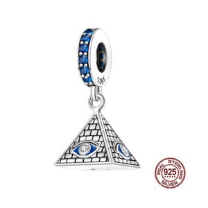 May include: Silver charm with a blue and white pyramid with an eye design. The charm has a blue crystal ring around the top and says "925" on the back.