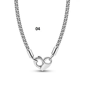 May include: A silver chain necklace with a heart-shaped clasp. The chain is made of small, linked circles.