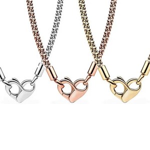 May include: Three necklaces with heart-shaped clasps. The necklaces are silver, rose gold, and gold.