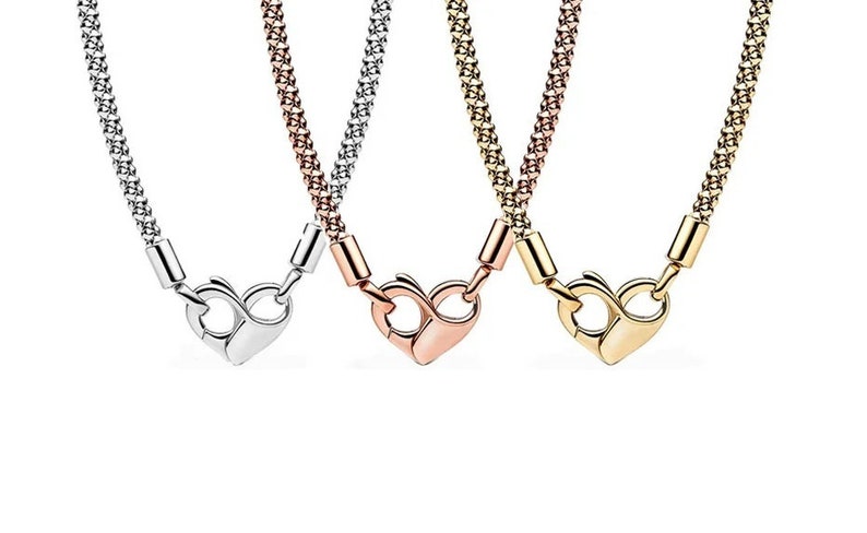 May include: Three necklaces with heart-shaped clasps. The necklaces are silver, rose gold, and gold.