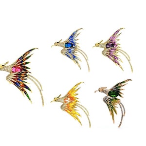 May include: Five gold-tone bird brooches with jeweled accents. Each brooch features a different colored gemstone: red, blue, purple, green, and yellow.