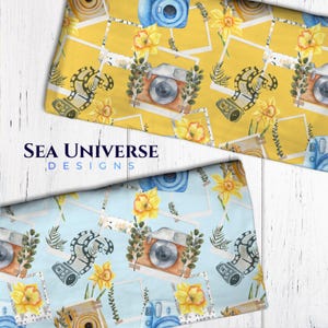 May include: A seamless pattern featuring watercolor illustrations of cameras, film strips, and daffodils on a yellow background. The pattern is perfect for fabric, wallpaper, or scrapbooking.