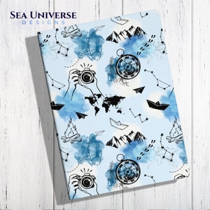May include: A notebook with a light blue background featuring travel-themed illustrations. The design includes a world map, compass, camera, mountains, paper airplanes, constellations, and the text "SEA UNIVERSE DESIGNS".