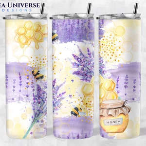 May include: A stainless steel tumbler with a lavender and honeycomb design. The tumbler features a watercolour-style design with bees, honeycombs, and lavender flowers. The tumbler has a clear lid and a straw. The text "Honey" is printed on the tumbler.
