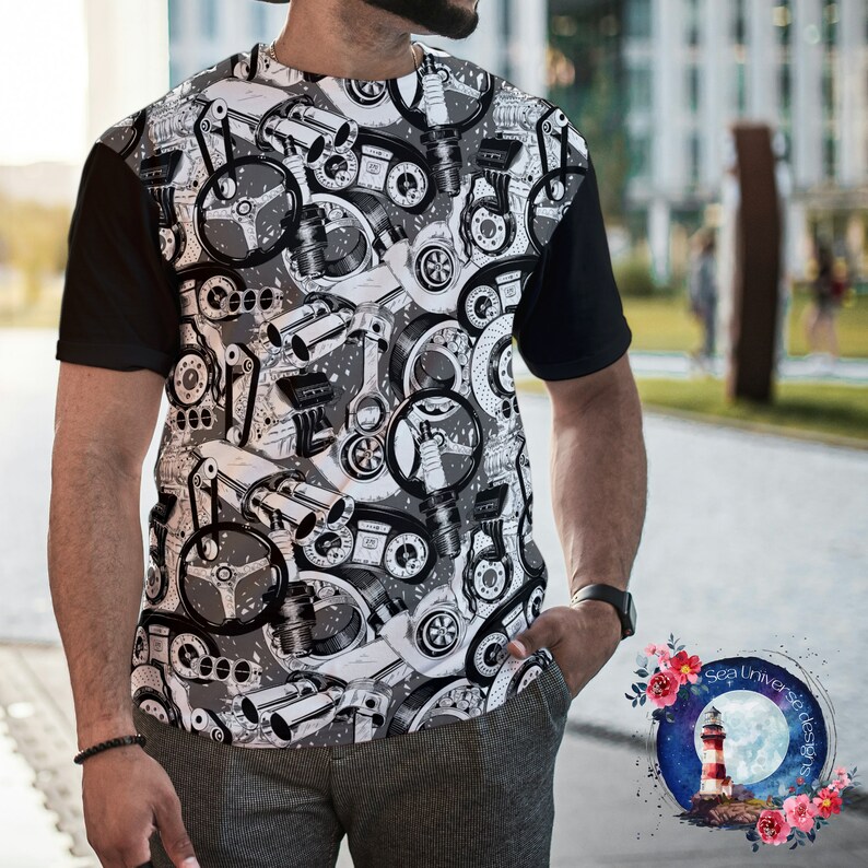 May include: A black and white t-shirt with a graphic print of various car engine parts. The shirt has a black collar and short sleeves.