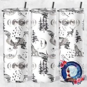 May include: A white tumbler with a black and white pattern of owls, wolves, deer, trees, and moons. The tumbler has a straw and a lid. The image also includes a logo for "Sea Universe Designs" with a lighthouse and moon.