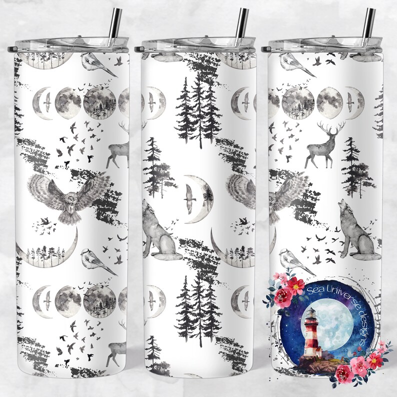 May include: A white tumbler with a black and white pattern of owls, wolves, deer, trees, and moons. The tumbler has a straw and a lid. The image also includes a logo for "Sea Universe Designs" with a lighthouse and moon.
