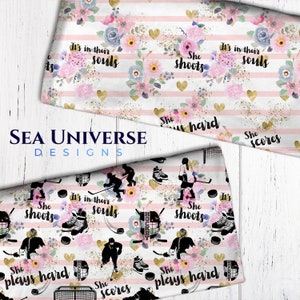 May include: Pink and white striped fabric with a floral pattern and gold glitter. The fabric features a hockey player silhouette with the text "She shoots", "She plays hard", "She scores", and "It's in their souls".