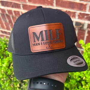 May include: Black trucker hat with a brown leather patch that says "MILF Man I Love Fishing" with a fishing hook graphic.