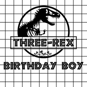 May include: Black and white graphic featuring a dinosaur silhouette inside a circle, with the text "THREE-REX" and "BIRTHDAY BOY" below. The design is set against a grid background, suitable for birthday celebrations.