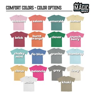 K&ouml;nnte beinhalten: Eine Tabelle mit 18 verschiedenen T-Shirt-Farben, wobei der Farbname auf jedem Shirt aufgedruckt ist. Die Farben umfassen Bl&uuml;te, Salom, Smaragd, Butter, Ziegel, gebrannter Orange, Klee, Crunchbeere, Kreideminze, Floblau, Granit, Chambray, Zitrone, Heloncia, Grau, Elfenbein, Wei&szlig; und Khaki.