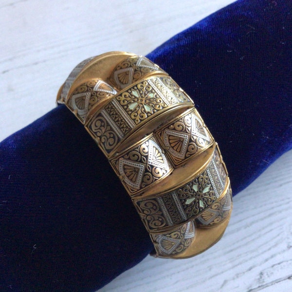 A vintage Toledo ware bangle with safety chain.