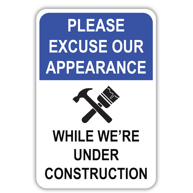 This is a white vertical aluminum sign with Please Excuse Our Appearance in white on top inside a blue rectangular background. A hammer and paintbrush are in black in the middle. While We're Under Construction is in black at the bottom.