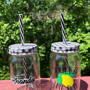 Violet glass cup with lid and straw on a white background isolated. Mason  jar with handle and screwed down cap. Empty mug no spill. Stock Photo