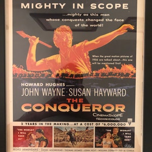 Framed Vintage 1956 Movie Advertisement for ‘The Conqueror ’’ starring John Wayne /Produced by Howard Hughes.