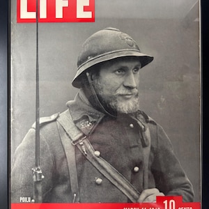 May include: Framed vintage LIFE magazine cover featuring a soldier in uniform. The cover has a red banner with the text "LIFE" and the date "MARCH 11, 1940". The price is listed as "10 CENTS". The soldier is wearing a helmet and has a beard.