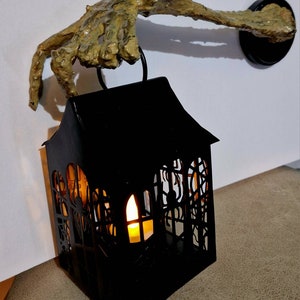 Skeleton arm holding lantern wall mounted candle holder