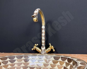 May include: A white and brown patterned faucet with gold accents is mounted above a wooden sink with a geometric pattern.