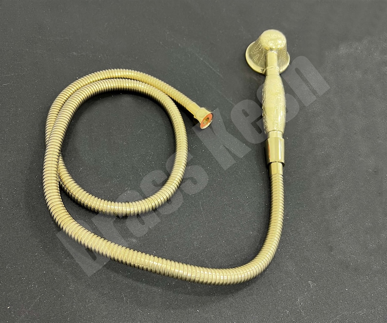 Pu&ograve; includere: Un soffione doccia portatile color oro con un tubo flessibile abbinato. Il soffione ha una piastra di spruzzo rotonda e un'impugnatura strutturata. Il tubo &egrave; a spirale e si collega al soffione e a un raccordo color rame.