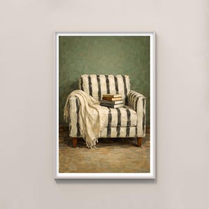 Puede incluir: Pintura enmarcada de un sillón a rayas con una manta crema y libros. El sillón tiene rayas verticales blancas y negras. El fondo es verde apagado y el suelo es marrón apagado.