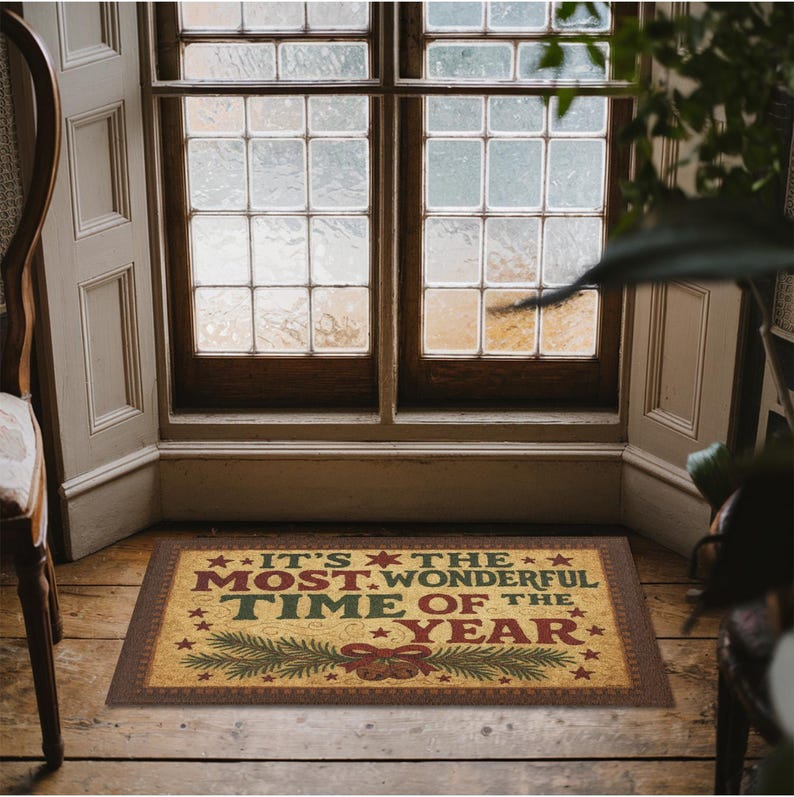 May include: A rectangular doormat with the text "IT'S THE MOST WONDERFUL TIME OF THE YEAR" in red, green, and yellow. The mat features a brown border and festive holiday imagery, including stars, pine branches, and a bow.