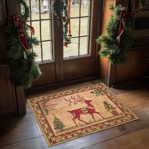 Può includere: Un tappetino da porta beige e rosso natalizio con una renna e il testo "Christmas 1717".