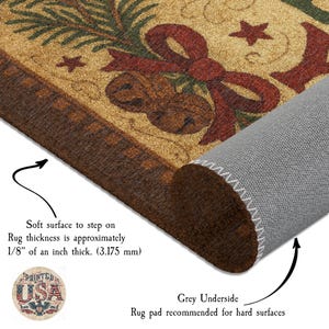 May include: A rectangular doormat with a festive design featuring a red bow, bells, stars, and greenery on a tan background. The rug has a brown border and a grey underside. The rug thickness is approximately 3.175 mm.