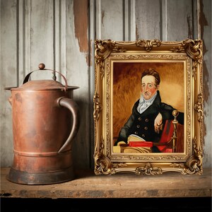 May include: A framed oil painting of a man in a black coat and white cravat, sitting in a red chair with a book in his lap. The painting is set against a gold background and has a gold frame.