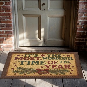May include: A rectangular doormat with the text "IT'S THE MOST WONDERFUL TIME OF THE YEAR" in red, green, and gold. The mat features a festive design with stars, pine branches, and bells, perfect for the holiday season.