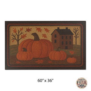 May include: Rectangular doormat featuring a fall harvest scene. The mat displays three orange pumpkins, a brown house, and autumn leaves. The dimensions are 60 inches by 36 inches.