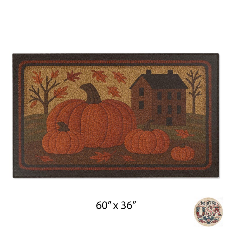 May include: Rectangular doormat featuring a fall harvest scene. The mat displays three orange pumpkins, a brown house, and autumn leaves. The dimensions are 60 inches by 36 inches.