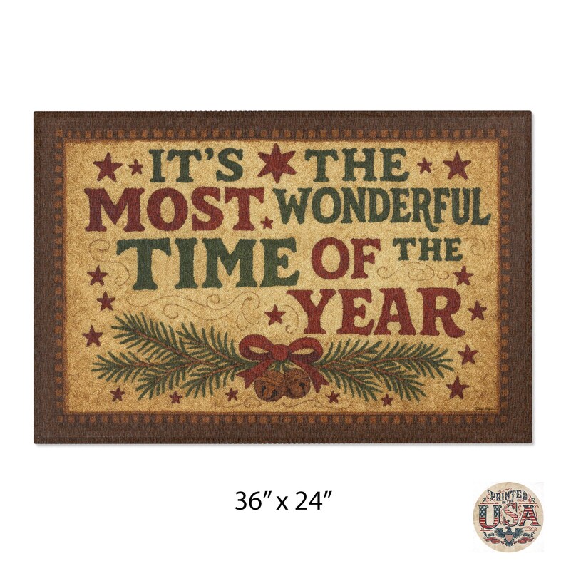 May include: Rectangular doormat with a brown border and a tan center. The text "IT'S THE MOST WONDERFUL TIME OF THE YEAR" is displayed in red and green. The mat measures 91 x 61 cm.