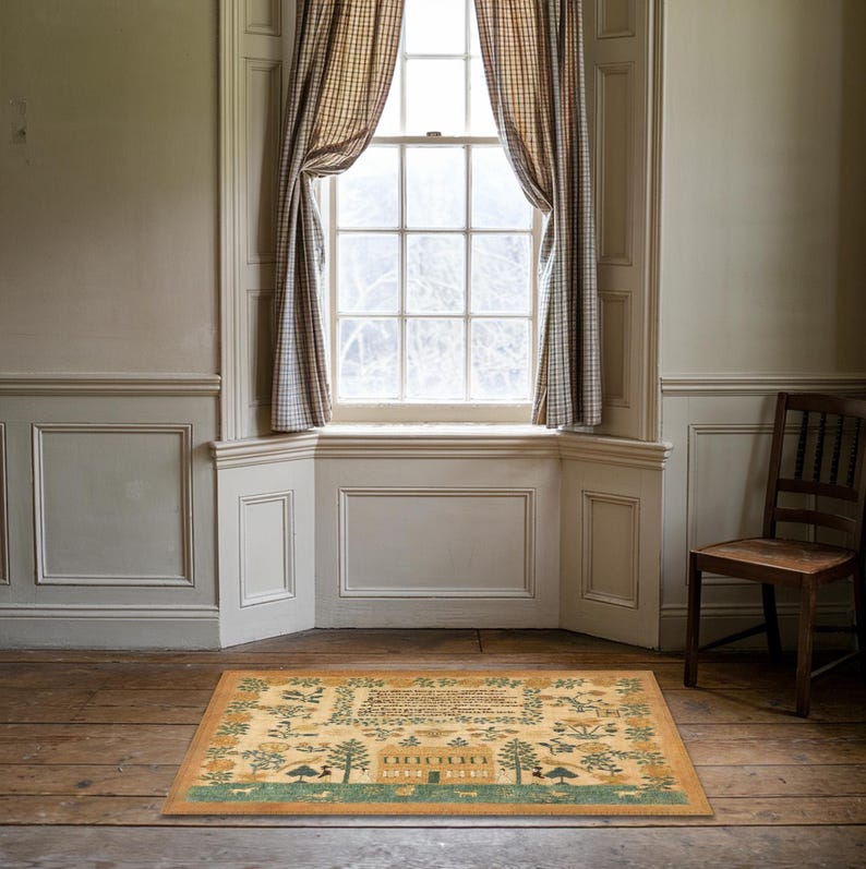 May include: A beige and green patterned rug with a house, trees, and flowers. The rug is in a room with white walls and a window with checkered curtains.