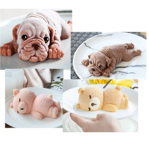 May include: Three silicone molds for baking: a brown and white pug, a brown and white shar-pei, and a light pink teddy bear.