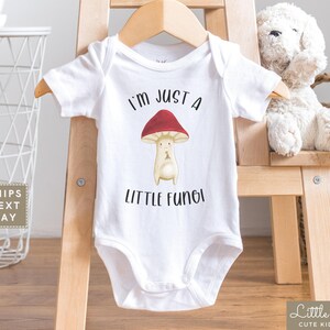 May include: White baby bodysuit with a red mushroom graphic and the text "I'm just a little fungi".