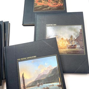 Puede incluir: Una colecci&oacute;n de libros de tapa dura con temas mar&iacute;timos. Las cubiertas son negras con ilustraciones enmarcadas en oro de veleros y escenas hist&oacute;ricas. Los t&iacute;tulos incluyen "The Venetians", "Fighting Sail" y "The Pacific Navigators".
