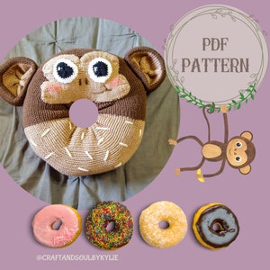 May include: Crochet pattern for a monkey donut pillow. The pattern is available as a PDF download. The image shows a brown and beige crocheted donut pillow with a monkey face. The donut pillow is sitting on a brown fabric surface. There are four donuts in the background, one pink, one with colorful sprinkles, one with white sprinkles, and one with chocolate icing.