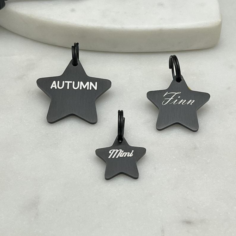 A collection of 3 sizes of stainless steel star shaped pet id tags. 
in black pvd coating with a brushed finish. personalized dog tags,
choose from several fonts.
precisely laser engraved in house by sunset pet tags.
made in the usa with 316 surgical stainless steel.