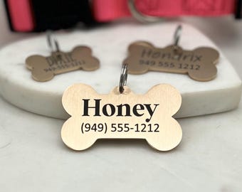 May include: Gold bone-shaped dog tag with the name "Honey" and phone number (949) 555-1212 engraved on it.