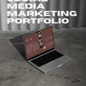 May include: A silver laptop displaying a brown digital social media marketing portfolio template with the text Hi, Im AMELIA SHYANN. The screen features a vertical photo strip, a pink lip icon, and descriptive text. The top includes Canva Digital Download text.
