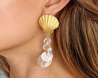 May include: Gold shell earrings with a dangling chain of white shell beads.