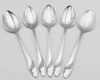 May include: Set of five silver teaspoons with floral designs on the handles.