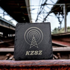May include: Black slate coaster with a white radio tower graphic and the text "KZ8Z" in white.