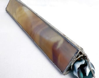 May include: A handmade kaleidoscope with a rectangular body and a round end. The body is made of stained glass in shades of brown, tan, and purple, framed with silver metal. The end features a dark green and white marble.