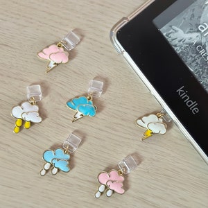 May include: Five colorful cloud-shaped book markers with gold accents and clear plastic holders. The markers feature different cloud designs with lightning bolts and raindrops.