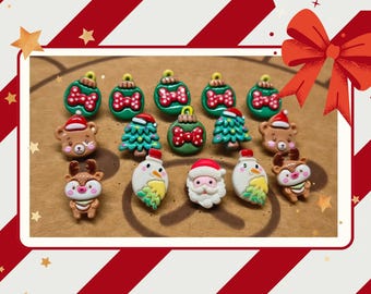May include: A collection of small, colorful Christmas-themed resin charms featuring green ornaments with red polka-dot bows, brown bears in Santa hats, green Christmas trees, a white snowman, a Santa Claus face, and brown reindeer.